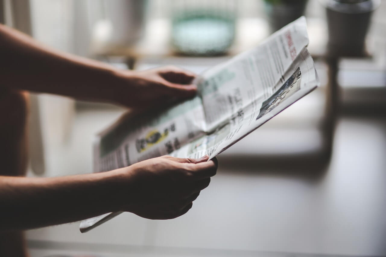 Close up of a property manager holding a newspaper manage